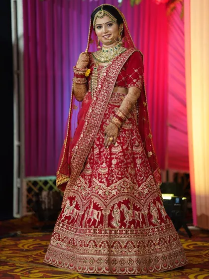 The wedding day glow is unmatched. Our bride looks absolutely breathtaking in her red lehenga, with makeup that enhances her natural beauty and will last through all the celebrations.