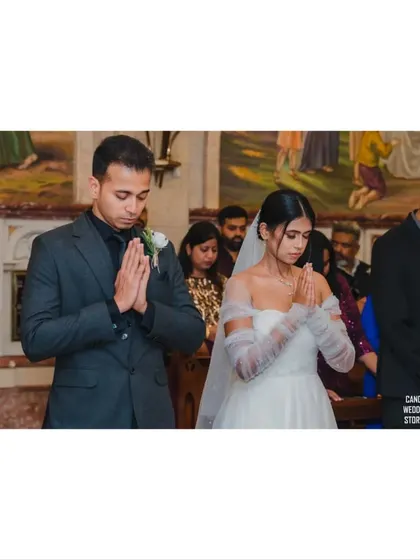 A moment of quiet prayer for the couple during their wedding mass, showing their shared faith and reverence.