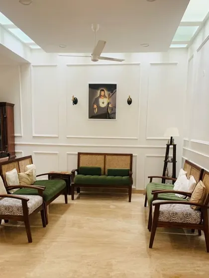 Which of these is that one chair that everyone fights over? A beautifully arranged living room with custom-made, classic wooden seating.