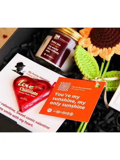 Another look at the 'Tunes of Love' hamper, focusing on the heart-shaped chocolate and song-themed cards.