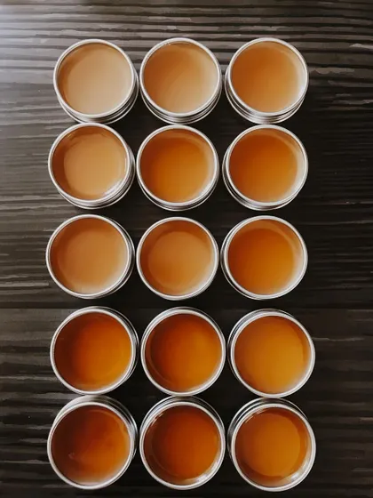 An overhead grid of freshly poured lip balms. This shows the consistency and care I put into making each and every batch.