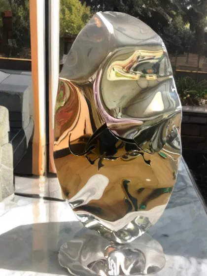 From my Bull Series, this freestanding sculpture features a bull engraving on a fluidly shaped piece of polished steel, symbolizing power and persistence.