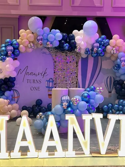 A closer look at the main stage for Maanvik's party, showing the detailed balloon arch and custom backdrop.