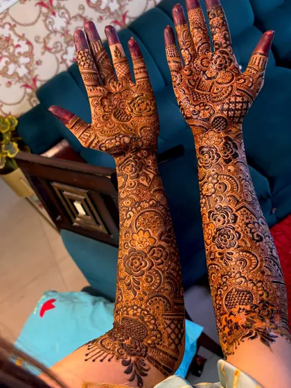 This full coverage bridal henna shows the beauty of a rich, dark henna application. The design is packed with detail, from the fingertips all the way up the arms.