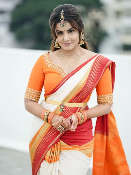 A beautiful smile that says it all. The client is holding her hands together, showing how the mehendi completes her traditional South Indian festive attire.