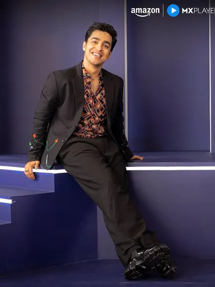 Gagan Arora posing for Amazon MX Player promotions in the full outfit I styled, featuring a unique embroidered blazer and patterned shirt.