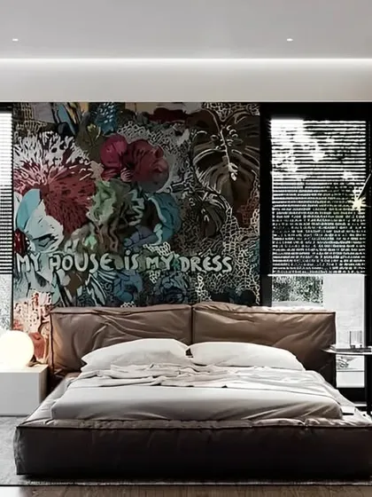 This bedroom design features a stunning floral mural that serves as a vibrant headboard. The floor-to-ceiling windows and glass-walled closet create an open, airy feel, seamlessly blending the interior with the surrounding nature.
