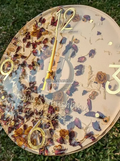 Another angle of the 12-inch wall clock made from preserved wedding flowers, showing the names and date clearly.