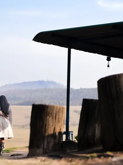 Walking away together towards the horizon. This shot from their destination pre-wedding session captures a feeling of journey and shared adventure against a beautiful, open landscape.