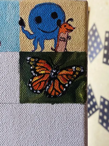 A mini-painting of a monarch butterfly.