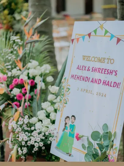 A personalized welcome sign for the Mehendi and Haldi ceremony, featuring a charming illustration of the couple.