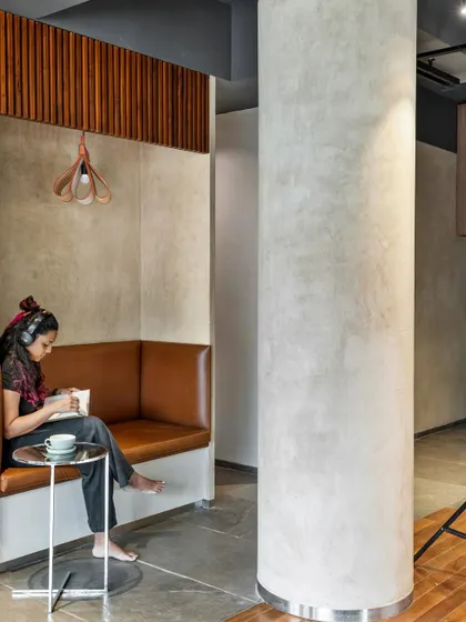 We integrated this snug reading nook to offer a tranquil space for reflection amidst the dynamic co-working environment. The use of warm upholstery, wood paneling, and focused lighting creates a sense of enclosure and comfort for focused, individual work.