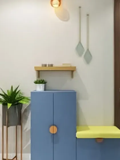We can add a pop of color to your entryway. This compact unit features a blue shoe cabinet with unique wooden handles and a matching bench with a bright yellow cushion, creating a cheerful and modern look.