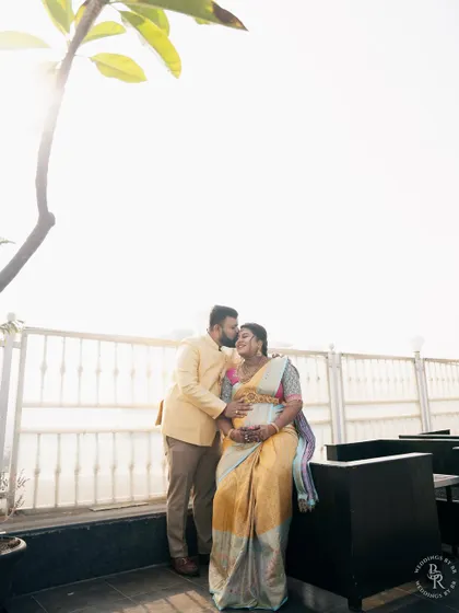 A beautiful backlit portrait of an expecting couple against a bright sky, capturing their connection and the joy of their journey together.