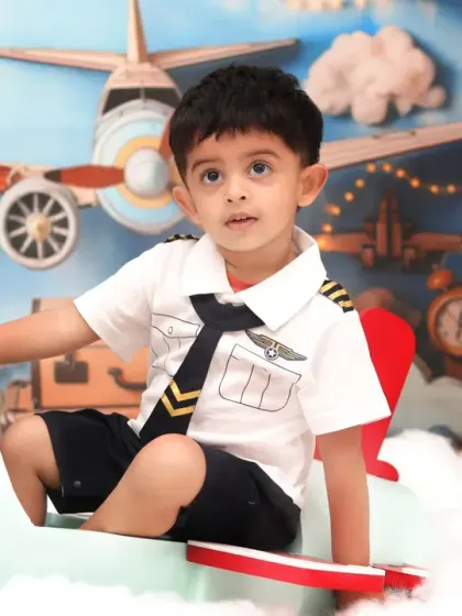 A slightly older child dressed as a pilot, looking confident and ready to command the skies in our detailed airplane set.