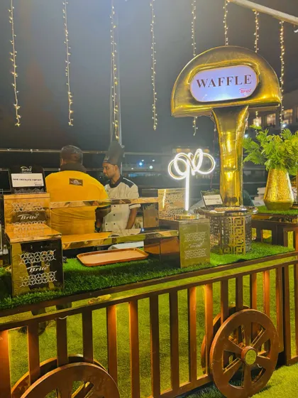 The full waffle station, elegantly designed with golden accents.
