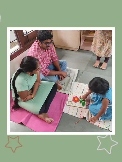 Working with a botany puzzle, Lalitha shows her parents the different parts of a flower. This activity cultivates a love for nature and a scientific vocabulary from an early age.