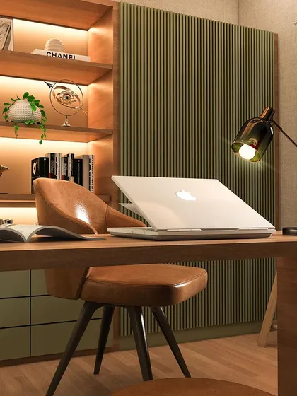 A closer look at the details of a luxury office revamp. The combination of a rich leather chair, a sleek desk lamp, and a textured green accent wall creates a sophisticated and comfortable workspace designed for focus and inspiration.