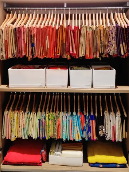 A beautifully organized saree closet, with each piece hung to be visible and accessible. We use special hangers and storage boxes to protect delicate fabrics and make finding the right one effortless.