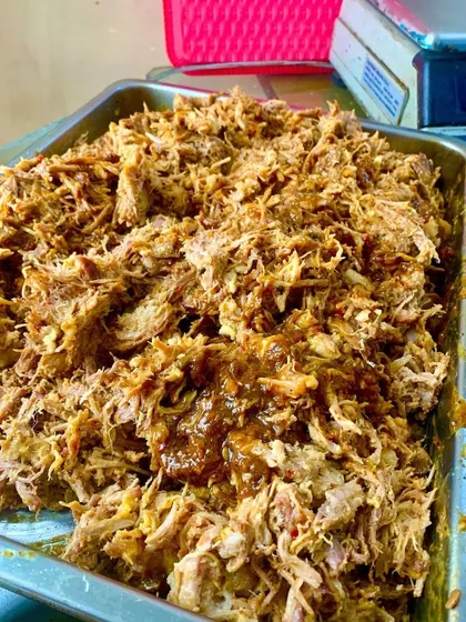 A generous tray of our signature Pulled Pork, slow-cooked for eight hours until it's perfectly tender. We then toss it in a rich, tangy tomato and BBQ reduction made from its own flavorful juices.