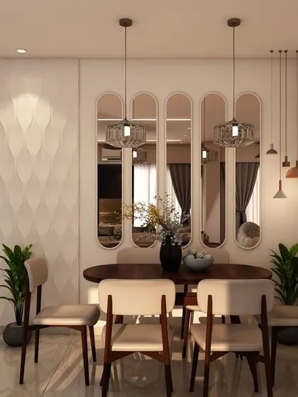 This dining area features a textured 3D wall, elegant pendant lights, and oval-backed mirrors that add depth and a touch of art deco glamour to the space.
