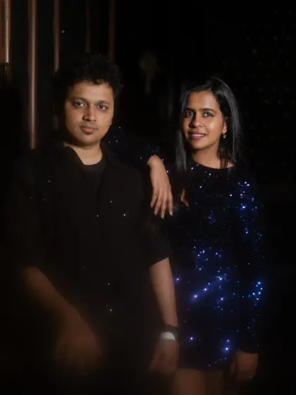 A cool, posed shot of the couple. The low-key lighting and their confident expressions give this photo a modern, stylish vibe.