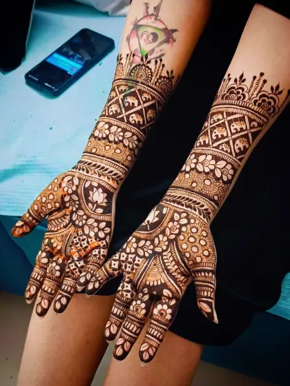 A full view of the elephant and lotus design, showing the client's arm tattoo as well.