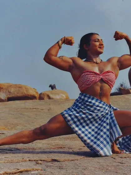 Work until you don't have to introduce yourself. A powerful lunge pose in a unique traditional outfit, showcasing my leg and upper body definition.