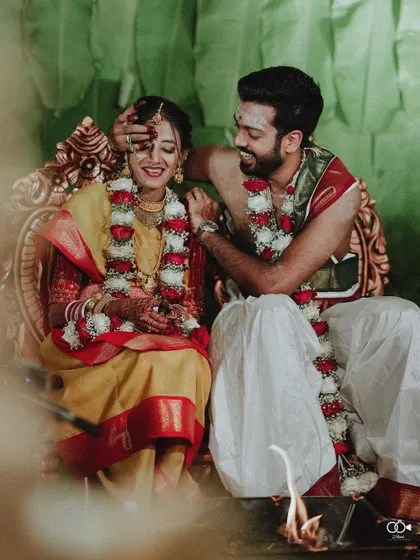 A sweet moment where the groom blesses the bride during a wedding ritual.