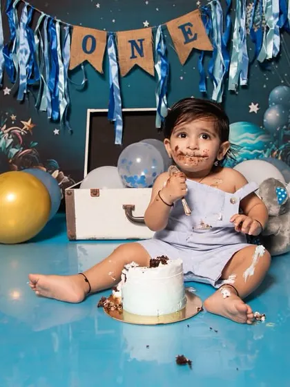 A cake smash session is all about capturing pure, unfiltered joy. This little one had the best time exploring his first birthday cake, and his messy, happy face is a perfect memory of this sweet milestone.