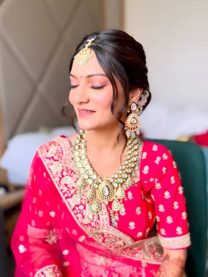 A happy, smiling bride. Her makeup is light and airy, letting her natural joy shine through while still looking perfectly polished.