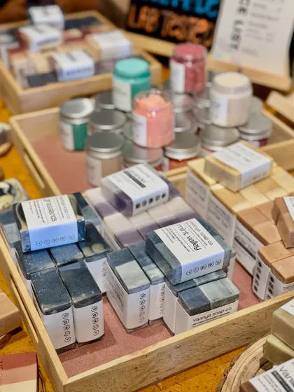 Another angle of our pop-up table, with trays filled with our colorful body polishes and neatly packaged soap bars.