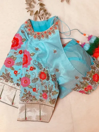 The full view of the light blue blouse, a standout piece.