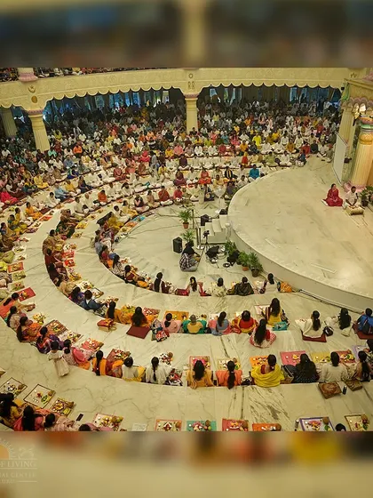 A wide shot of the Guru Puja ceremony in the Sumeru Mantap. The circular arrangement allows everyone to feel connected and part of a single, unified gathering.