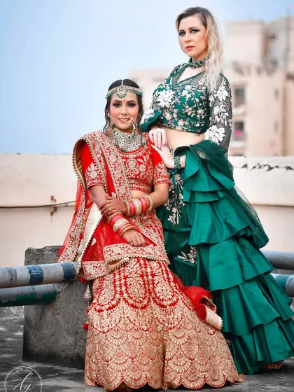 A lovely photo of the bride with her 'saheli' or best friend. This shot captures the bond between them, with their contrasting red and green outfits creating a beautiful visual.