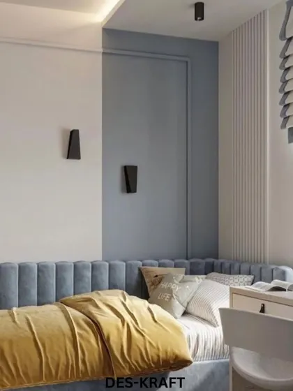 This angle shows the sleek wall sconces and the simple, modern lines of the bed, creating a space that is stylish enough to grow with the child.