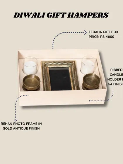 This is our Feraha gift box, a perfect Diwali hamper. It includes a Rehan photo frame in a gold antique finish and a pair of ribbed candle holders.