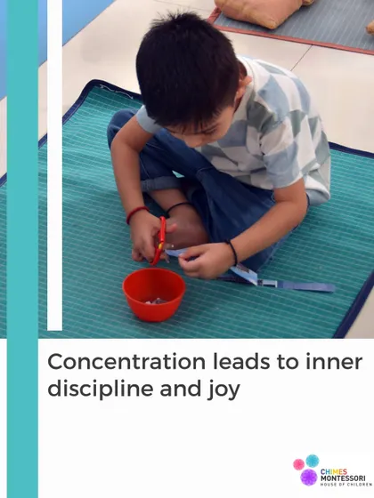 Concentration leads to inner discipline and joy. This child is carefully cutting paper strips, an activity that requires precision and focus.