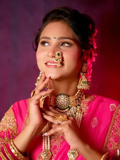 An artistic portrait of the bride, looking away with a gentle smile. The lighting and her pose create a dreamy and timeless image.