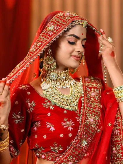A close-up of our 'Padmavat' inspired bridal lehenga, detailing the exquisite jewelry and the rich embroidery on the velvet blouse and sheer dupatta.