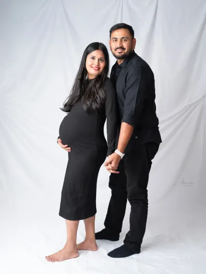 A simple and sweet couple's portrait. Holding hands and smiling, their happiness and anticipation are clear to see.