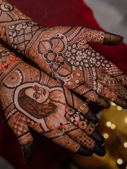 This custom bridal mehndi features a portrait tribute to a beloved late sister, surrounded by intricate floral and traditional patterns, keeping her memory alive.