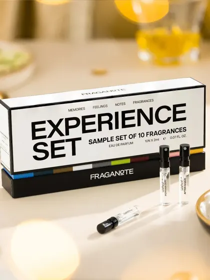 This shot for Fraganote's "Experience Set" uses a warm, festive background with soft bokeh lights to convey a sense of discovery and luxury, making it an ideal gift item.
