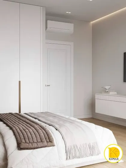 A minimalist white bedroom with simple, clean lines and handleless wardrobes.
