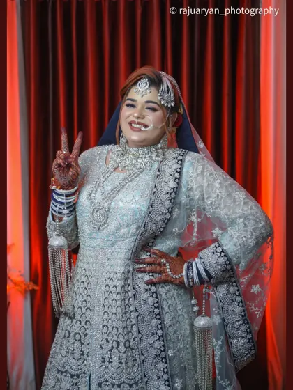 Capturing the fun side of the wedding day! This bride flashes a peace sign, showing that bridal portraits can be both beautiful and full of personality.