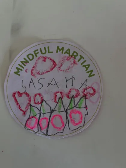 This camper decorated their "Mindful Martian" badge with hearts and flowers. It's beautiful to see their unique personalities shine through in their creative work.