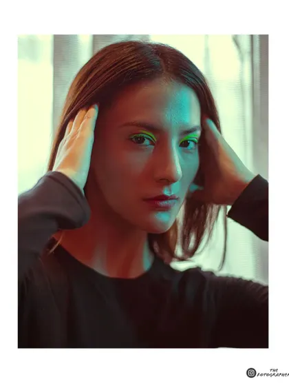 An experimental portrait using a mix of green and warm light. This technique creates a unique, futuristic mood perfect for an edgy portfolio.