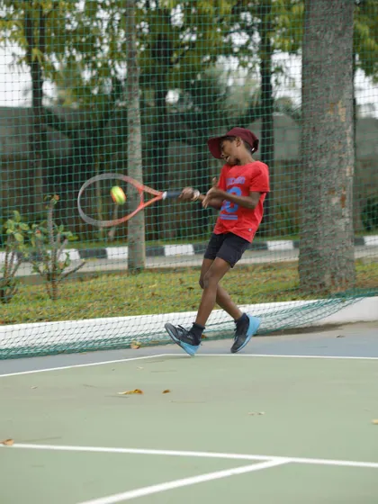 This action shot captures the focus and determination of a young player in our junior program. We teach them to move their feet and prepare for every shot, building the foundations of good court habits.