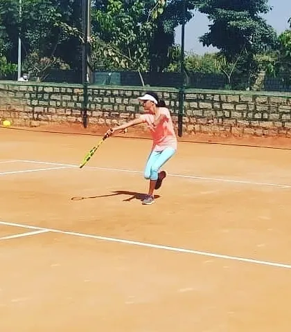 A female player hits a clean backhand slice during a UTR tour match at the academy.