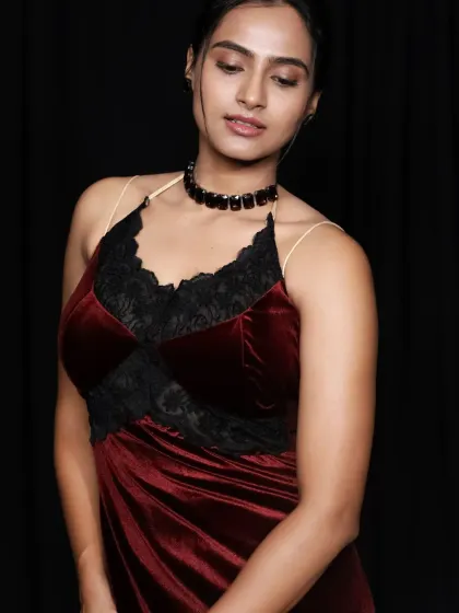 A beautiful close-up portrait highlighting the texture of the velvet and the delicate lace trim.